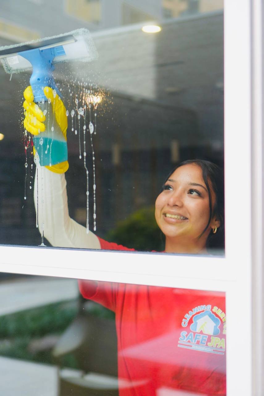 SAFE JPA team member cleaning a window